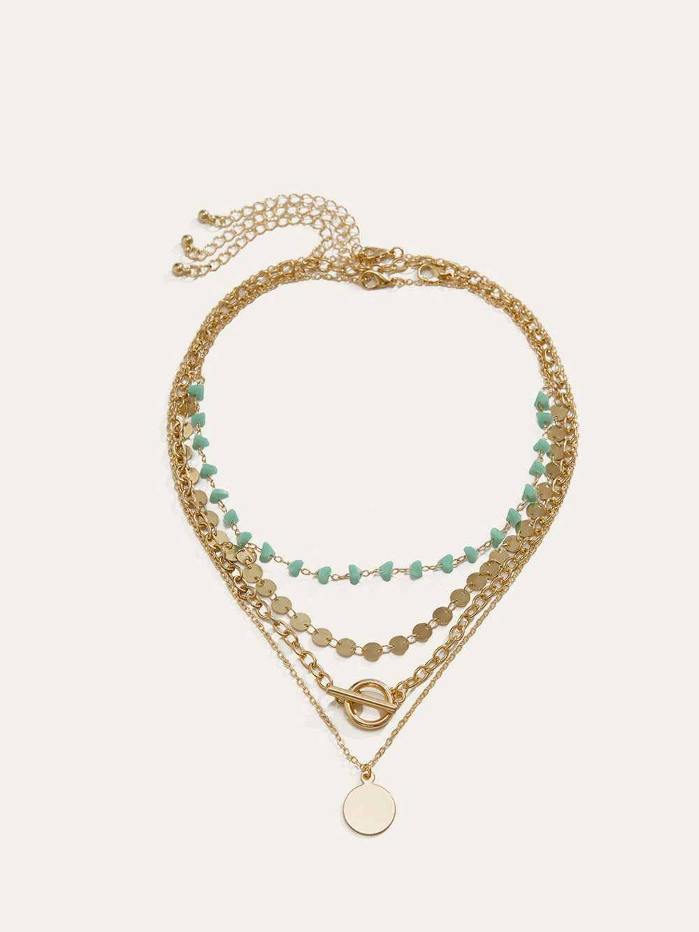 Mehrschichtige Goldkette mit Türkisperlen und Kreispendant